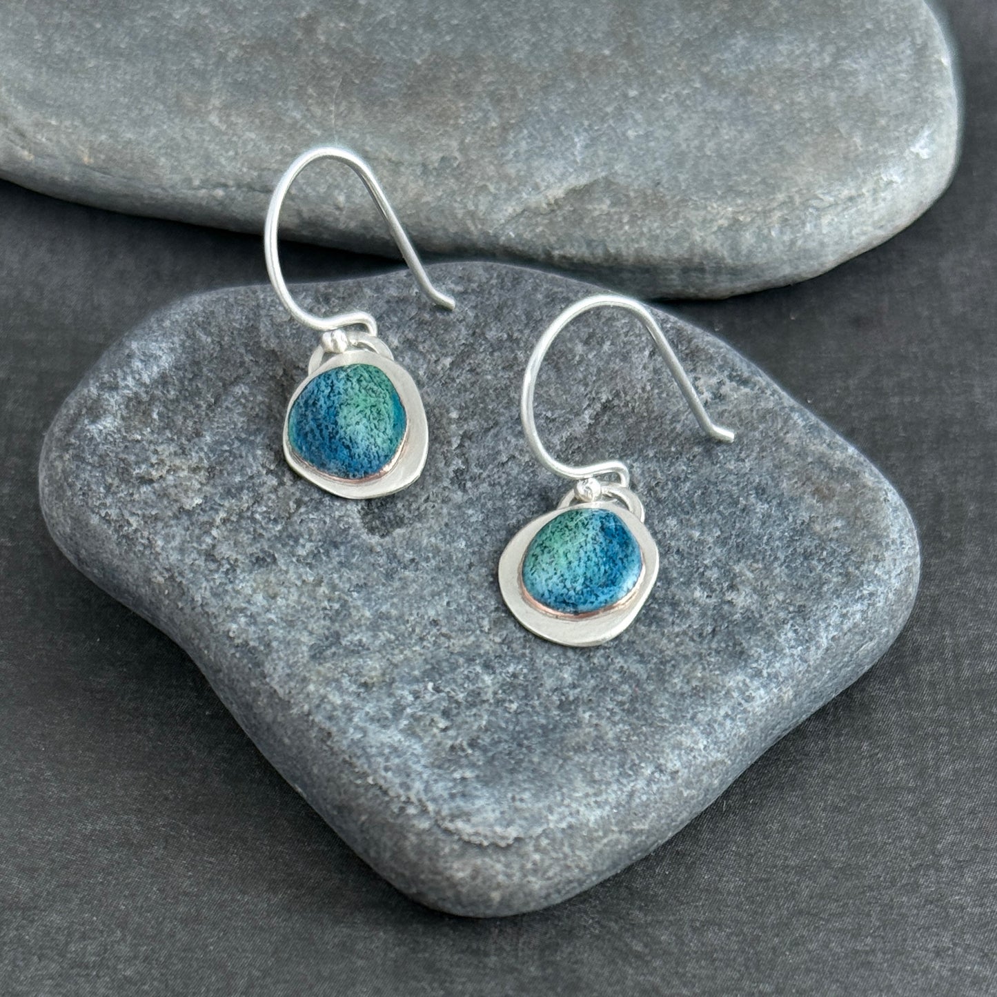Silver earrings with blues and green colored details